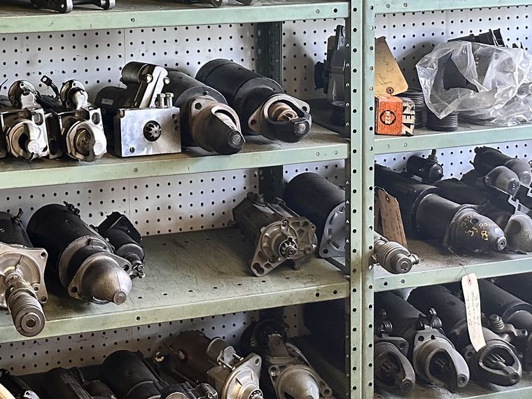 Rebuilt starters on the parts wall at D&D Auto Electric